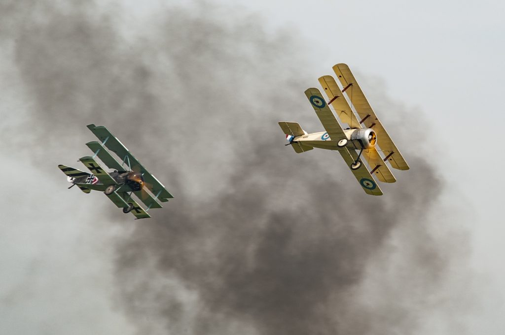 Sopwith Triplane and Fokker Triplane replicas re-enacting a WWI dogfight over Duxford