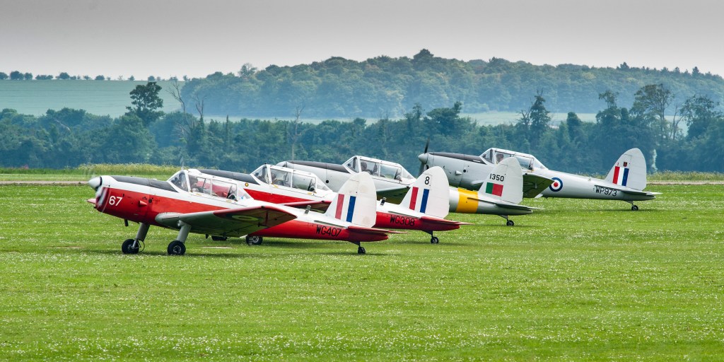 Four DHC Chipmunk aircraft lined up for take-off at Duxford