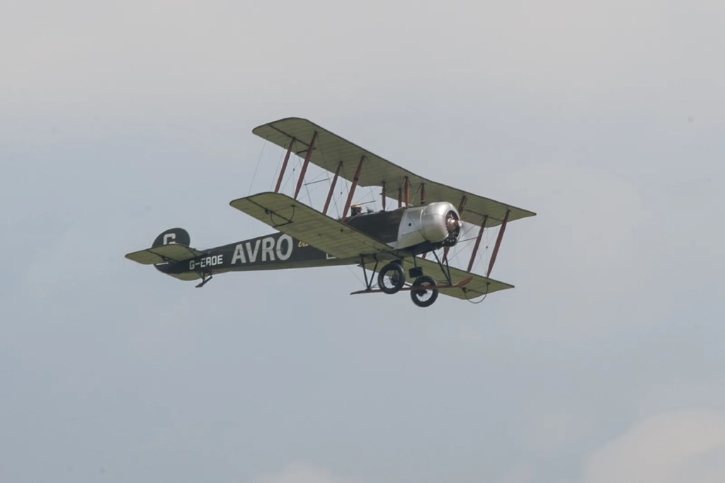 Avro 504 biplane G-ERDE banking in flight at Duxford