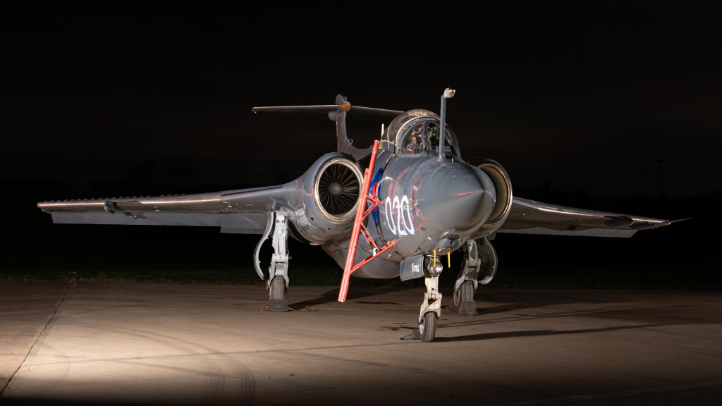 Blackburn Buccaneer XX894 at night, nose-on in grey colours coded 020, with a boarding ladder against the cockpit