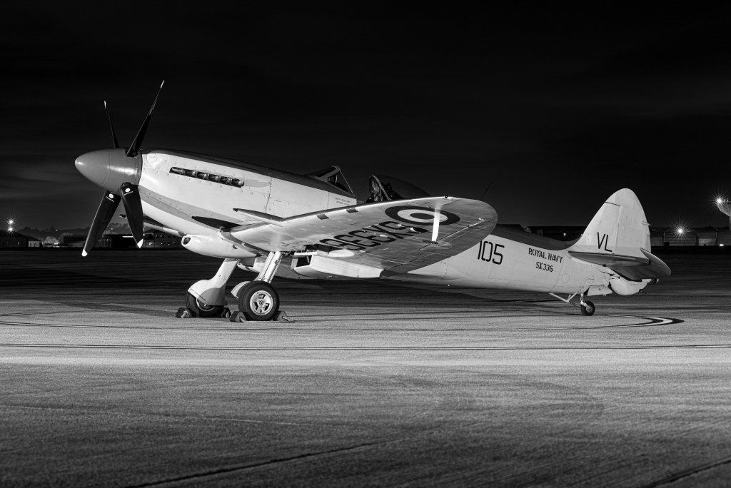 Black and white night view of Seafire SX336 from the side with 105 and VL marked on the fuselage and tail